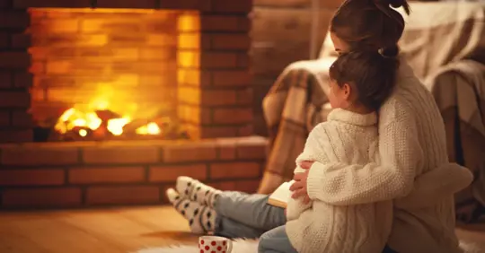 Mother and child near a fireplace